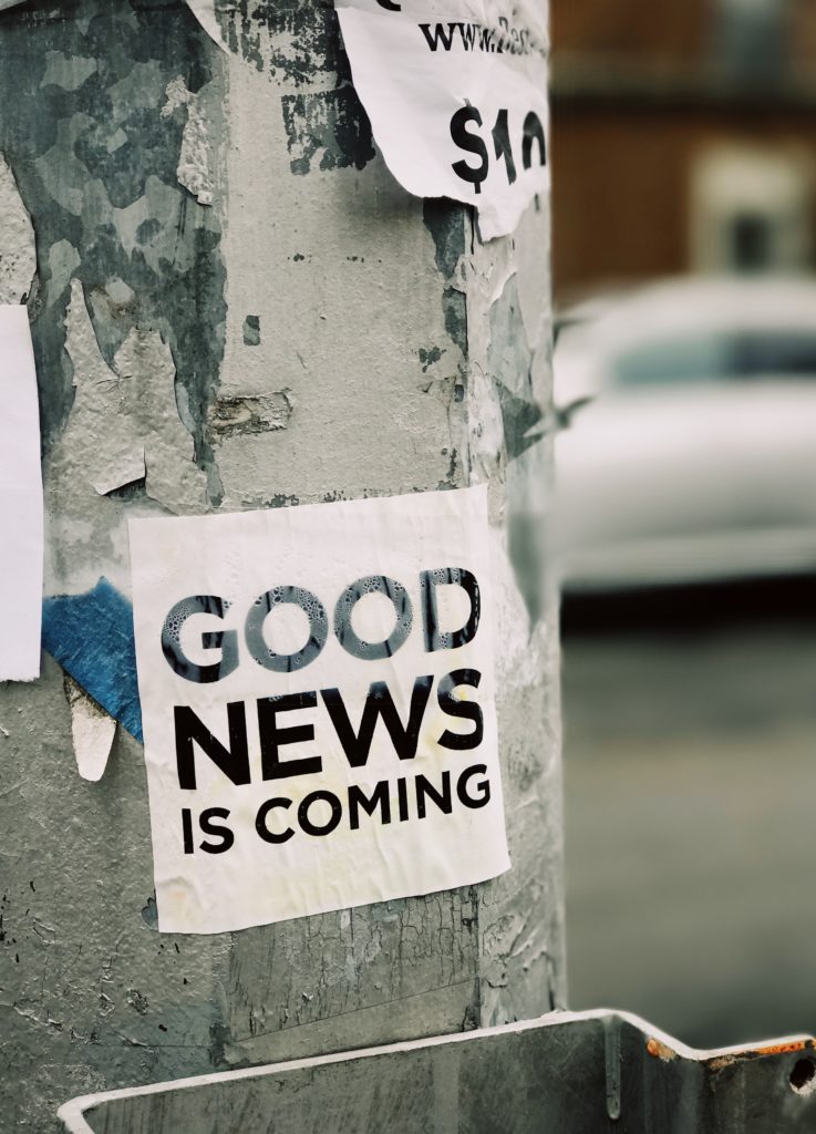 white Good News Is Coming paper on wall - communication