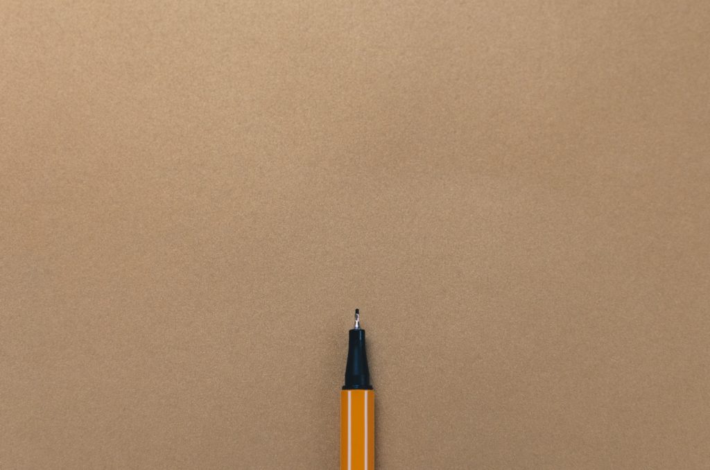 pen on brown board